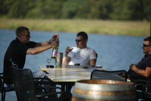 Enjoying wine by the lake.